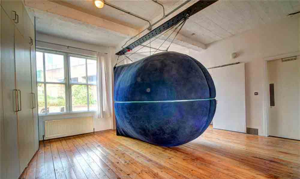 Giant capsule hanging in the middle of an apartment causing strangeness in a property for sale in the United Kingdom. Source and images: Rightmove